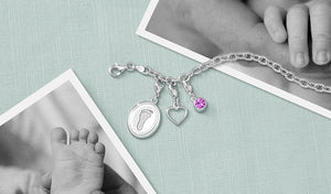 sterling silver charm bracelet engraved with a baby's footprint