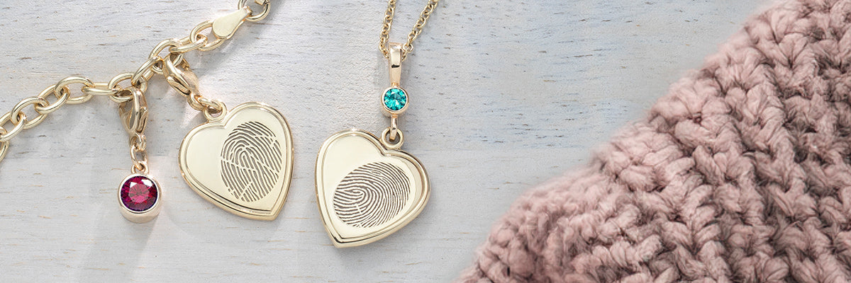 yellow gold fingerprint heart charm necklace and oval charm bracelet with symbolic charm and birthstone charm