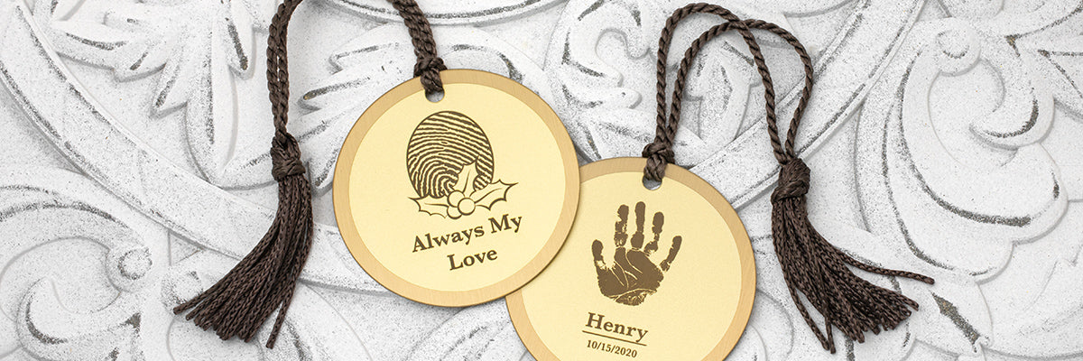 brass keepsake Christmas ornament engraved with a fingerprint in the shape of a heart with angel wings and a halo