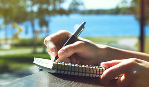 person writing in a notebook