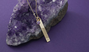 yellow gold vertical bar fingerprint pendant necklace with a purple birthstone charm