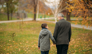 grandpa walking with his grandchild