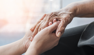 person holding their grandparent's hand