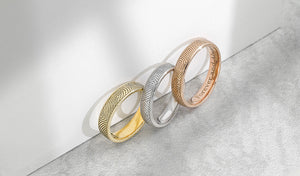 yellow gold white gold and rose gold rings with fingerprints
